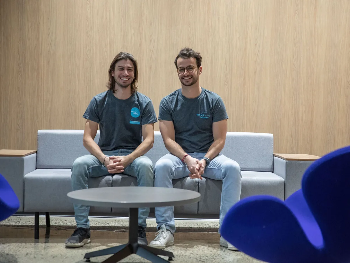 MoveMate founders seated on a sofa in the company office